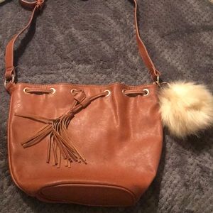 Bucket bag with fringe drawstring.